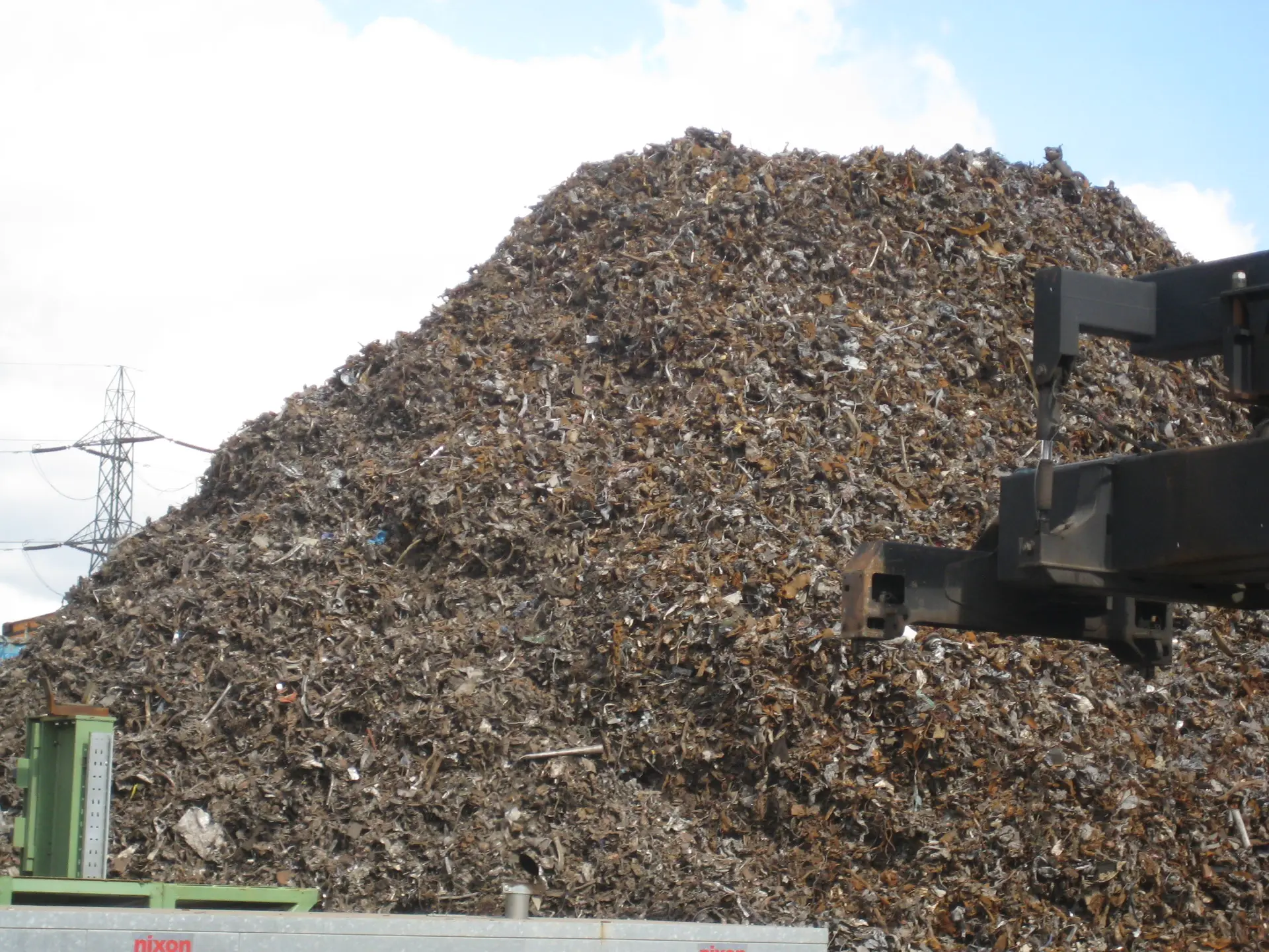 Shredded steel scrap stockpile ready for shipment